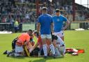Brandon Pickersgill receives treatment on the pitch before being stretchered off. Pictures: Tom Pearson