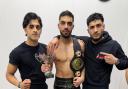 New English champion Owais Khan (centre), flanked by brother and fellow fighter Uzair Khan (left) and team-mate Sohail Khan.