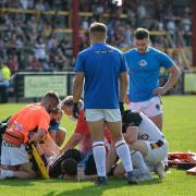 Brandon Pickersgill receives treatment on the pitch before being stretchered off. Pictures: Tom Pearson