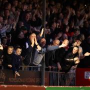 Crawley fans celebrate their team's third goal last night