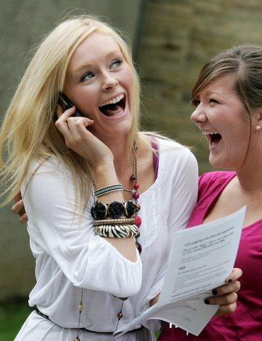 Skipton Girls High School student Holly Brook (three As) tells her mum with Charlotte Sangster (two As).