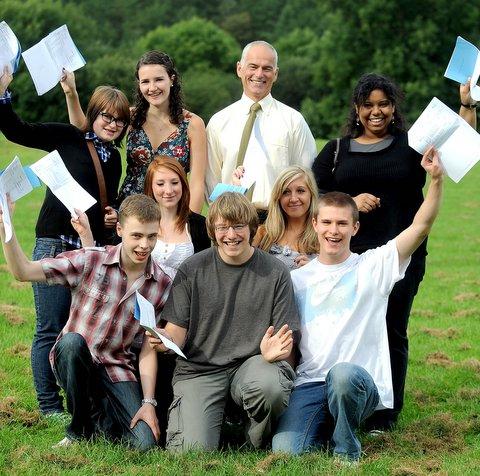 Bingley Grammar School students celebrate their results with head teacher Chris Taylor.