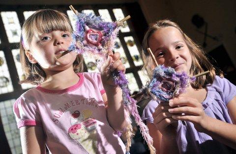 Sisters Caitlin (left) and Julia Baczkowski are pictured making God’s Eyes at an African weaving workshop at historic Bolling Hall 