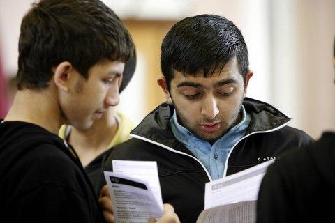 Students at Greenhead School, Keighley, study their results.