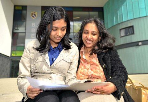 Buttershaw Business and Enterprise College students Nethmini Liyanamanagi, left, and her mum looks at her results.