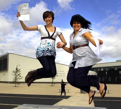 Tong High School students Katie Whitworth, left, and Kirti Mistry jump for joy at their results.