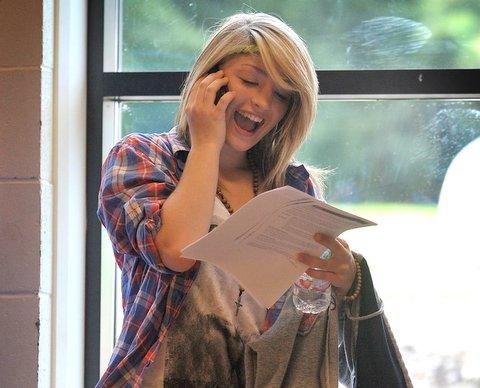 A Bingley Grammar School student phones home with her results.