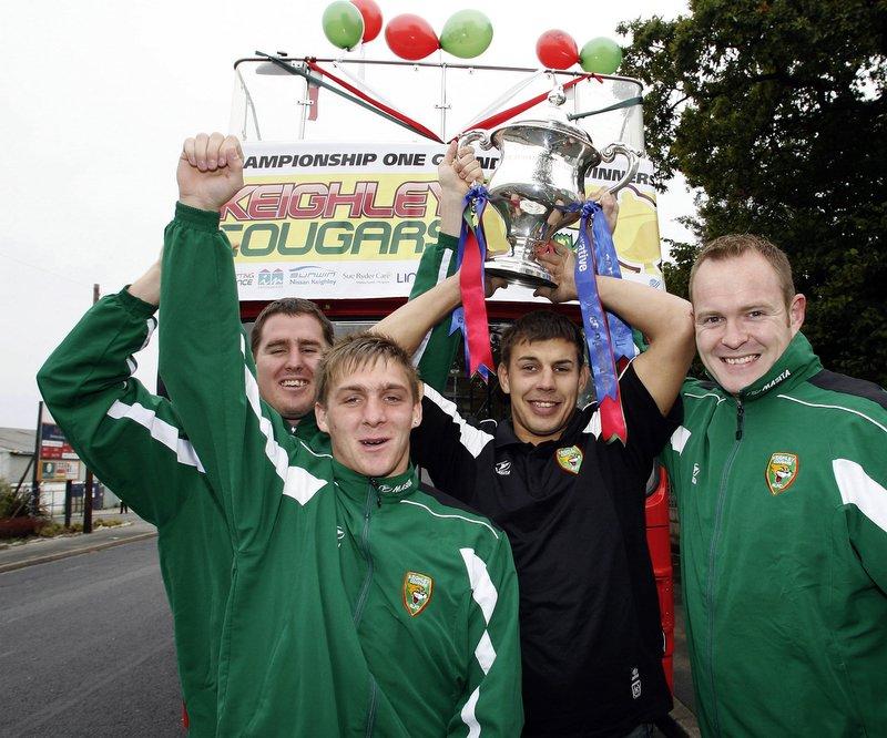 Preparing for their open-top bus parade are Cougars players, from the left, Brendon Rawlins, Gavin Duffy, James Feather and Craig Brown.