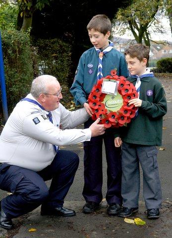Steven Clayton, Scout leader for 1st Sildsen Scouts, prepares John Lockwood, 13, and Jordan Hinchliffe, nine, for laying the wreath.