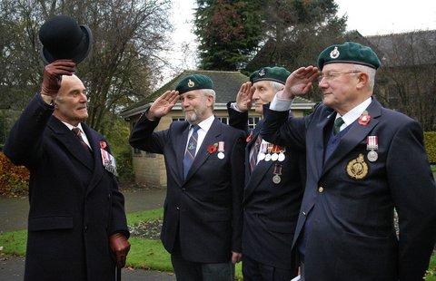Brian Bellas MBE, former Royal Marine (1954 to 1991) returns the salute of his former men, left to right, John Feet Giovanni Polly, and Bernard Breese at Ilkley's Remembrance Day Parade.