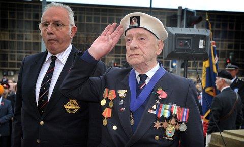James Brewer lays a wreath and salutes during the Remembrance Day Parade in Bradford city centre.