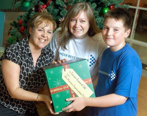 A Bradford boy who beat cancer has received an early Christmas present of £1 million on behalf of Cancer Research UK.
Ewan Barker, 10, of Little Horton, was able to say ‘thank you’ for the money raised by shoppers and staff at Bradford-based Morriso