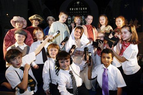 Pupils from Haworth Primary School get the latest news in their production of 'Witnesses' in the village's Parish Church.