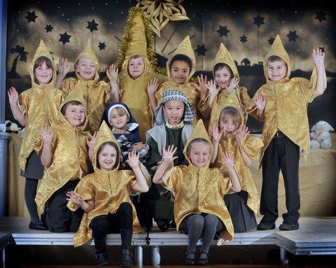 Some of the cast of Wibsey Primary School Nativity 'Shine Star, Shine', with stars surrounding Ella-Mae James as Mary and Michael Voong as Joseph.