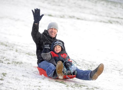 Anthony Handy and son Antony, 5, sledging in Bradford's Peel Park.