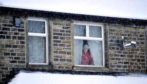 A Steeton resident looks out at the snow.