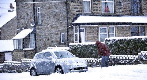 A motorist tries to dig out his care in Steeton.