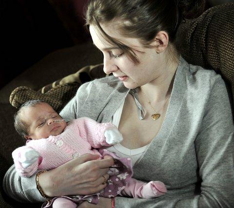 A baby born prematurely as her mother lay critically-ill with swine flu has finally been allowed home.
Miley Amber Brewin was due on January 24 but arrived on November 4 as her mum Jodie Brewin, 20, fought for her life in Bradford Royal Infirmary. 