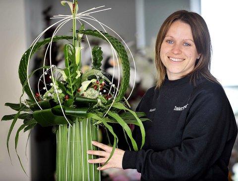 Trophy-winner Sarah Toulmin proudly displays the flower arrangement which won her a top prize. 
Sarah, who works at her family’s Eastells Florist in Shipley, won the Bretherick trophy for her ‘Skyline’ design awards at the Harrogate Spring Flower S