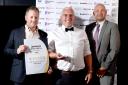 Simon Hobson (centre) and Jack Sutcliffe (left), of Power Sheds, after being named SME Business of the Year at the awards