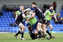 Max Wood (green) gets tackled in Warrington's Super League victory at London Broncos earlier this month.