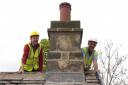 James Innerdale, architect and historic buildings consultant, and Carl Johnson of Kilburn & Johnson lay the final ridge slate to complete the re-roofing of Settle Quaker Meeting House.
