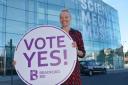 Jo Quinton-Tulloch with the Vote Yes board outside the Museum