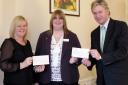 From the left, Barbara Keiss, Sally Napper and Russ Piper with the cheques