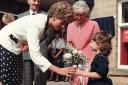 Princess Diana accepts a posy during a visit to the district.