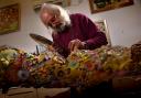 Buddy Brook at work in his studio. His wood carvings reflect various artistic styles