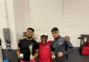 The two winning boxers and their head coach. Pictured, left to right: Adam Samad, Julian Cyprien and Arsalan Ahmed.