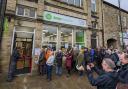 Author Adrian Tchaikovsky cutting the ribbon at the new Oxfam book shop in Skipton