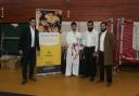 Rehman Ahmed Noor (centre) celebrates his success at Bradford United Martial Arts Academy's annual championships with, from left, taekwondo coach Mohammed Zamoord and Youthway's trustee Asad Hussain and head of volunteer programmes Hassan Jabar