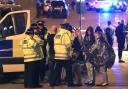 Police console fans after last night's bombing at an Ariana Grande concert in Manchester. Photo: PA Wire