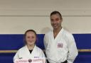 Becca Young poses with her black belt certificate