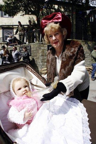 Mavis Hoyle takes care of a baby during the Haworth 1940s Weekend.