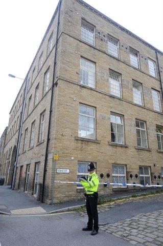 Police stand guard outside the Holmfield Court residence of murder suspect Stephen Griffiths on Thornton Road, Bradford.