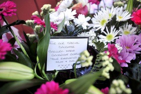 Floral tributes to the three women left outside Holmfield Court.