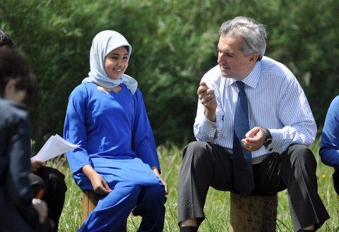 Chris Huhne, Secretary of State for Energy and Climate Change, visiting Thornbury Primary School following the Cabinet meeting in Bradford. He'spictured here with pupil Atika Naz.