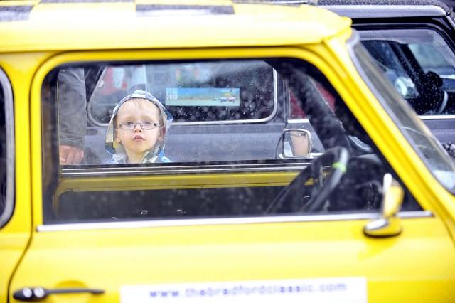 A young visitor inspects a classic Mini at the Bradford Classic 2010 event in Centenary Square