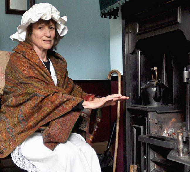 Sue Macinstosh warms her hands by the fire of one of the refurbished cottages at Bradford’s Industrial Museum. 
Sue is a member of The Friends of Bradford Art Galleries and Museums who are celebrating their 50th anniversary next month. 
