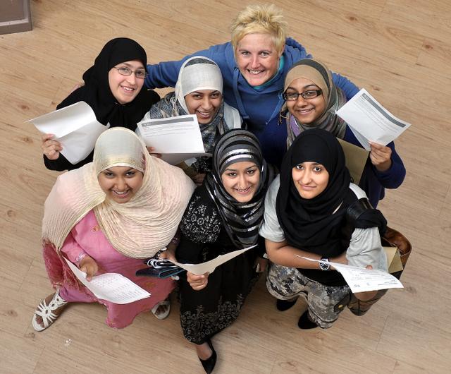 Clockwise from top left: Nayab Tariq, Jannath Alam, Aminah Alam, Sadia Amin, Nighat Parveen and Mariha Mushtaq with their A-level results at Feversham College with head teacher Clare Skelding top right.