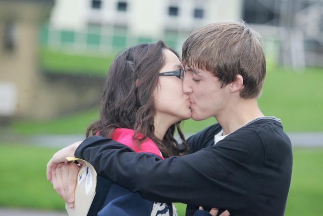 James Bannister gets a kiss from girlfriend Kelly Cheung as they collect their GCSE results at South Craven School