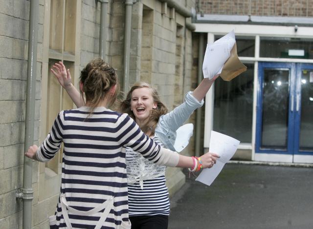 Lauren Brooks and Katie Holmes hug at Aireville School, Skipton, after collecting their results