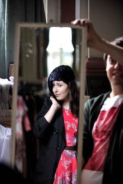 Madeline Hankin tries on a hat from the vintage fashion fair in Victoria Hall, Saltaire, as part of the Saltaire Festival