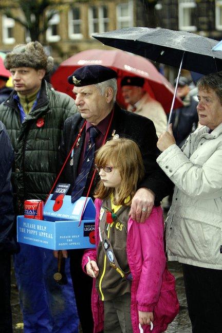 Young and old stand together in Town Hall Square, Keighley, for the Remembrance Day service.