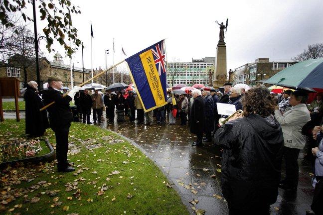 The British Legion standard is lowered in Town Hall Square, Keighley, during the Remembrance Day service.