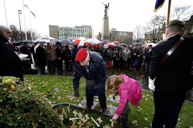 Young and old place their crosses in Town Hall Square, Keighley, during the Remembrance Day service.