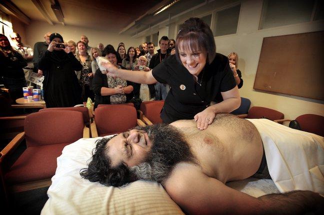 Children in Need will benefit from this chest waxing which was held at the Job Centre on Manningham Lane. Wincing in pain is the poor subject security guard Zeb Khan - administring the agony is Laura Mcilhagga.