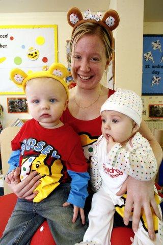 Senior nursery nurse Paula Jowett is joined by Alfie Caswell, six months, left, and Max Leighton, 16 months, at Bridge House Nursery, Steeton, where staff and children dressed in spotted clothes for Children in Need.